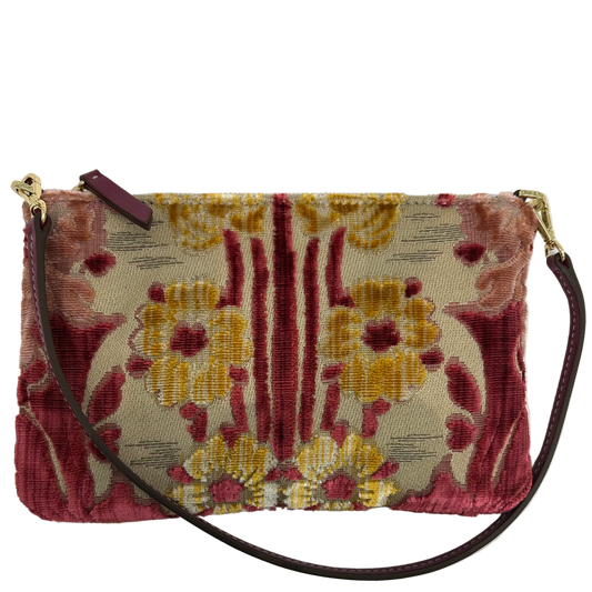 Floral patterned handbag with a strap on a light gray background
