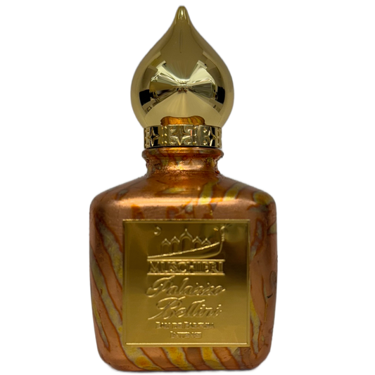 Gold perfume bottle with a decorative cap on a white background