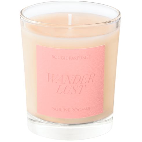Candle with a pink label reading 'Wanderlust' by Pauline Rochas on a white background