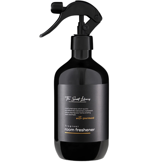 Black room freshener spray bottle with a label on a white background