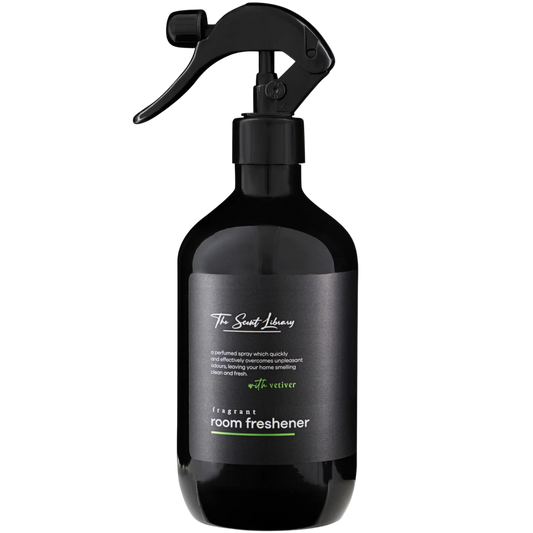 Black room freshener spray bottle with a label on a white background