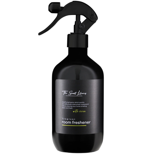Black room freshener spray bottle with a label on a white background