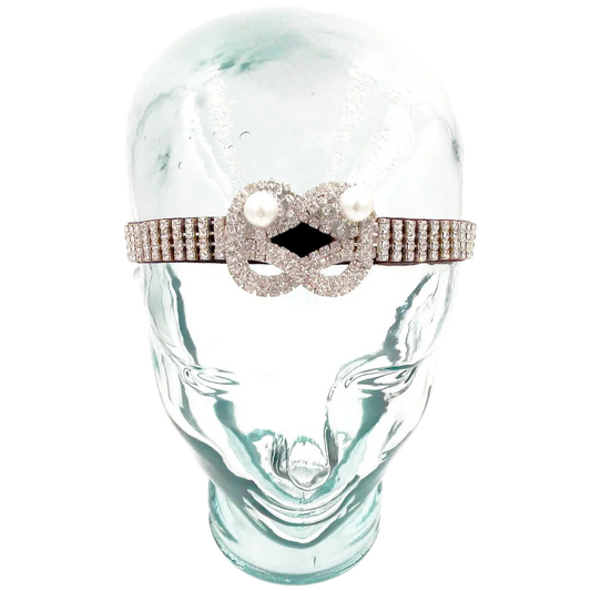 Decorative headband with pearls and crystals on a glass mannequin head.